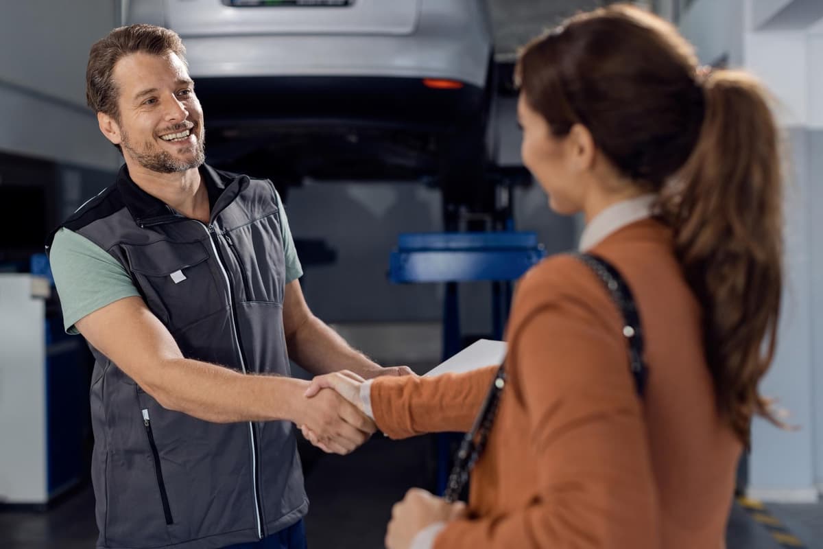 Two business owners shaking hands in a workshop