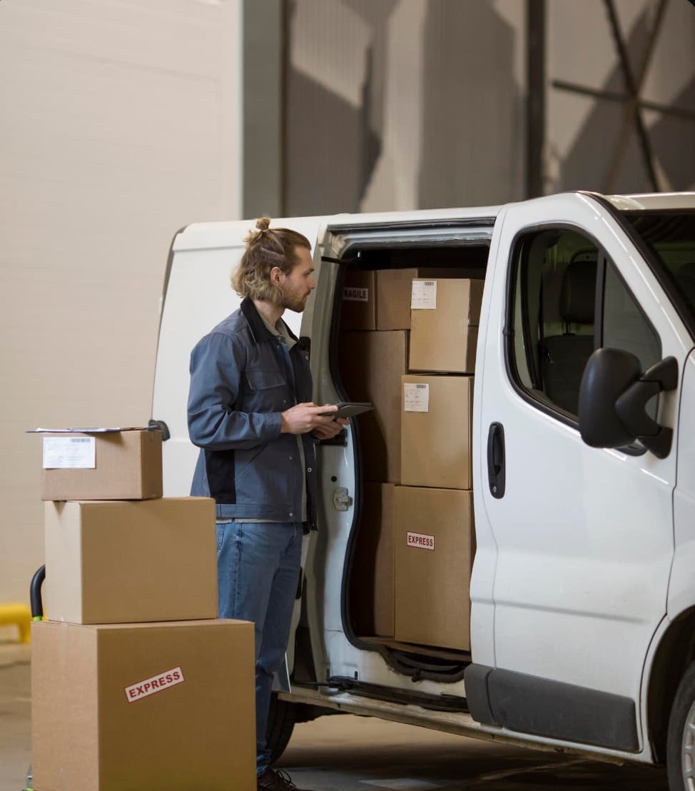 Courier with parcels checking a delivery address