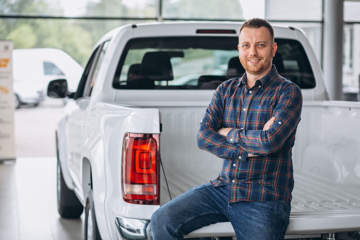 Business owner leaning on a pickup truck